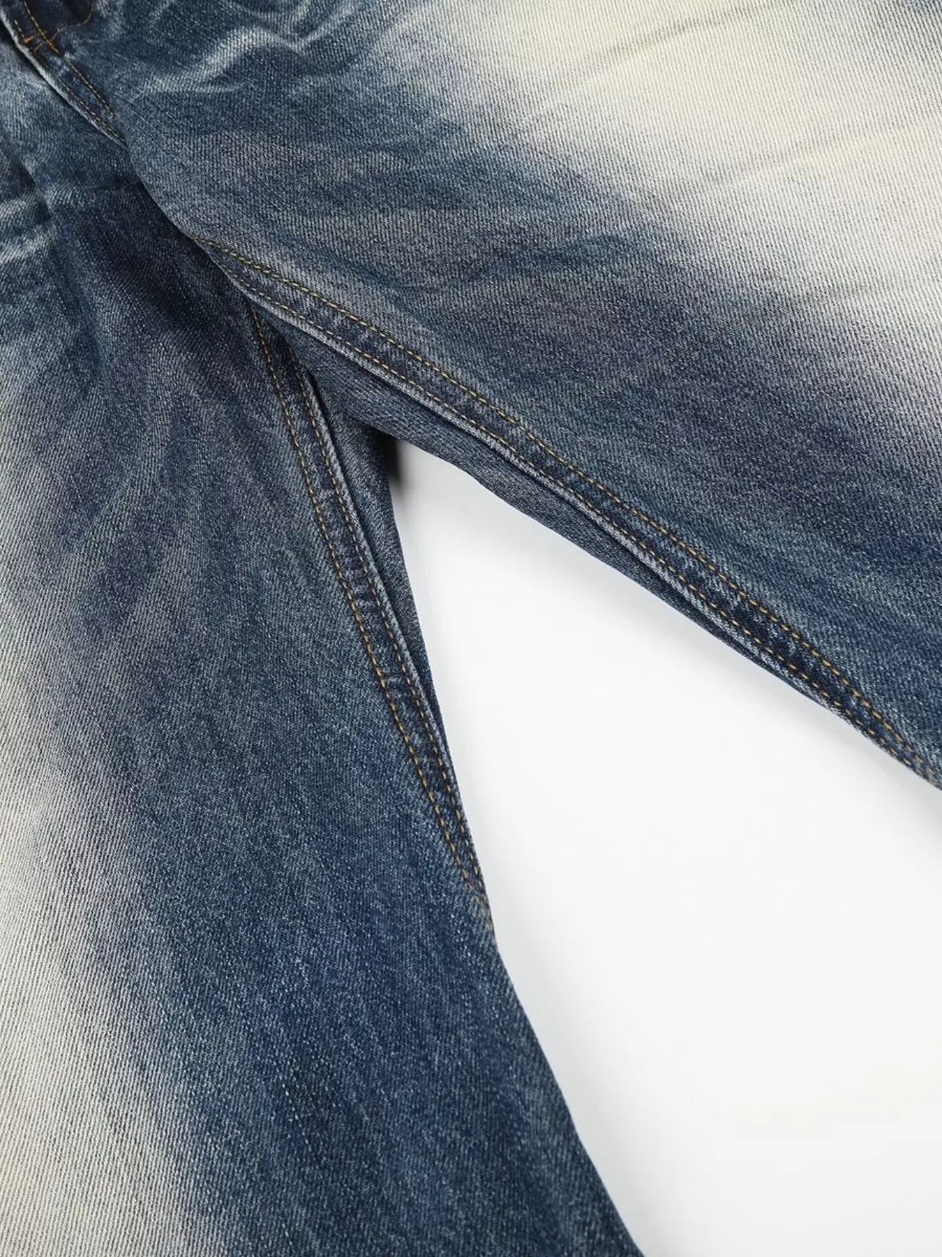 Men's washed bootcut jeans with studded details from Trendsi, showcasing a casual fit and trendy distressed denim style.