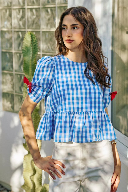 Blue SO ME 4th of July gingham blouse with ribbon details and short sleeves, designed by Trendsi.
