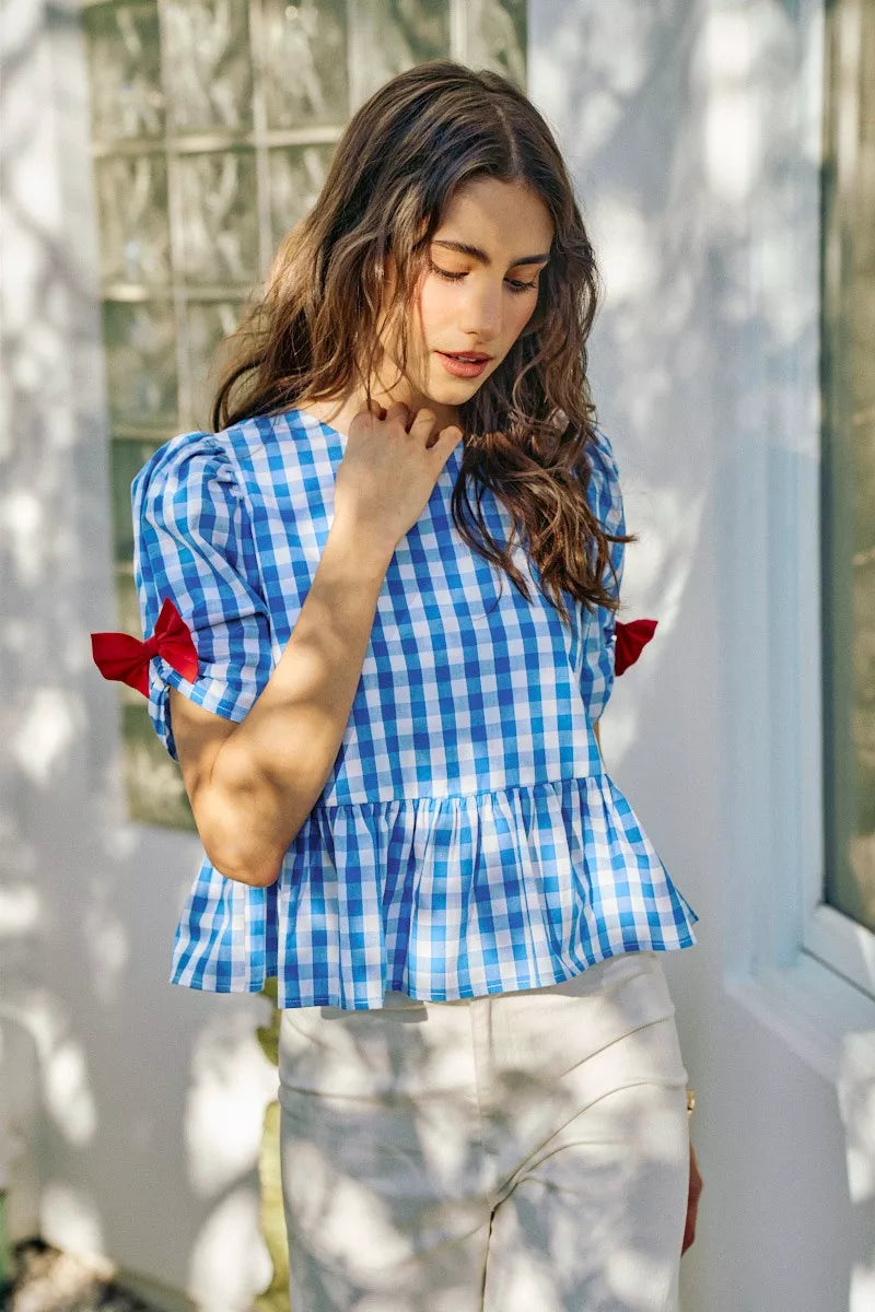 Blue SO ME 4th of July gingham blouse with ribbon detail and short sleeves, designed by Trendsi.