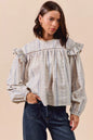 Blue floral cotton print ruffled long sleeve blouse by Trendsi, featuring feminine design and lightweight fabric.