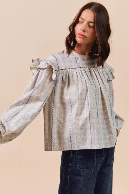 Blue floral cotton print ruffled long sleeve blouse from SO ME by Trendsi, featuring a feminine design and soft fabric.