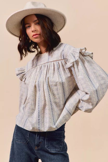 Blue floral cotton print ruffled long sleeve blouse from SO ME by Trendsi, featuring feminine ruffle details and a relaxed fit.