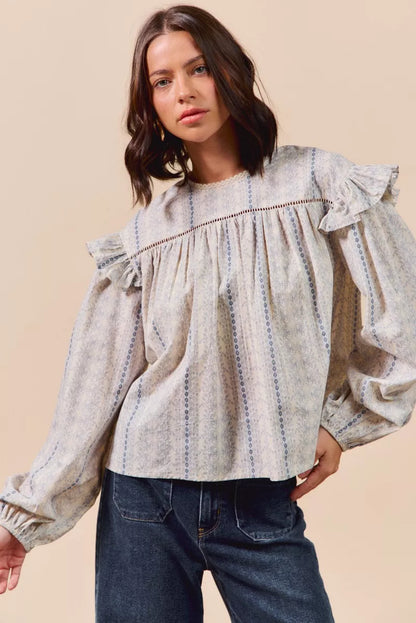 Blue floral cotton print ruffled long sleeve blouse from SO ME by Trendsi, featuring feminine ruffle details and lightweight fabric.