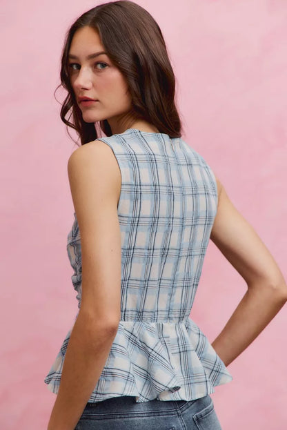 Blue plaid sleeveless ruffle peplum top by Trendsi, featuring a fitted waist and stylish ruffle details.
