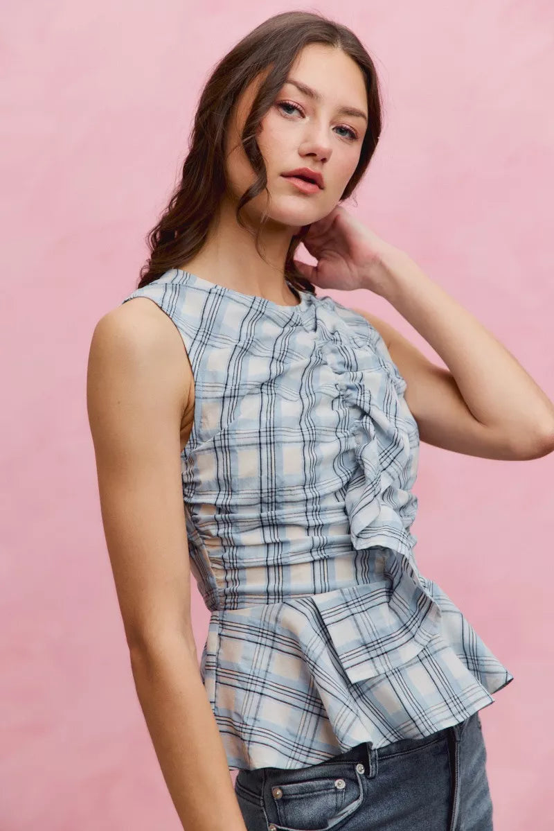Blue plaid sleeveless ruffle peplum top by Trendsi, featuring a stylish design with ruffles and a fitted peplum waist.