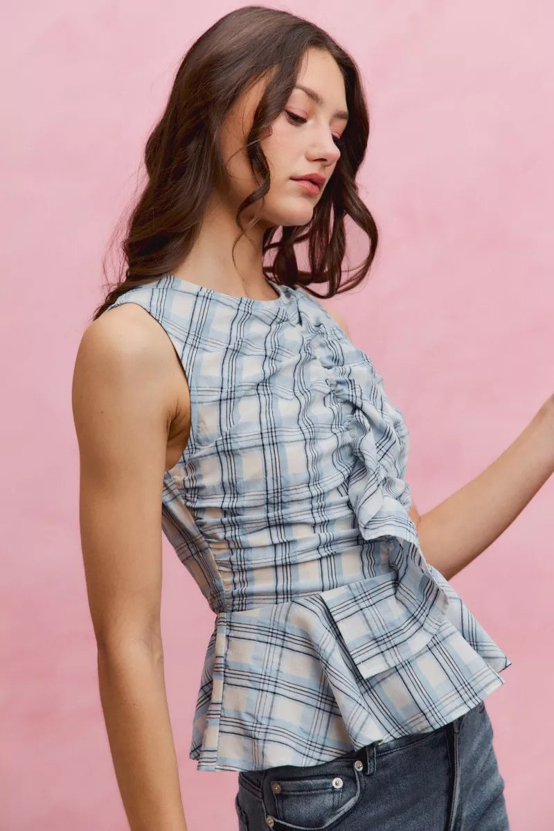 Blue plaid SO ME sleeveless ruffle peplum top by Trendsi, showcasing ruffled details and a fitted peplum silhouette.