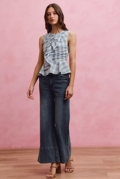 Blue plaid sleeveless ruffle peplum top from SO ME by Trendsi, featuring a stylish peplum hem and ruffled details.