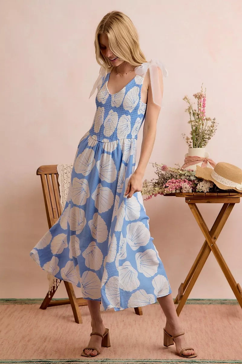 Blue SO ME Shell smocked bodice midi dress with shoulder tie details, lined, from Trendsi, displayed on a hanger.