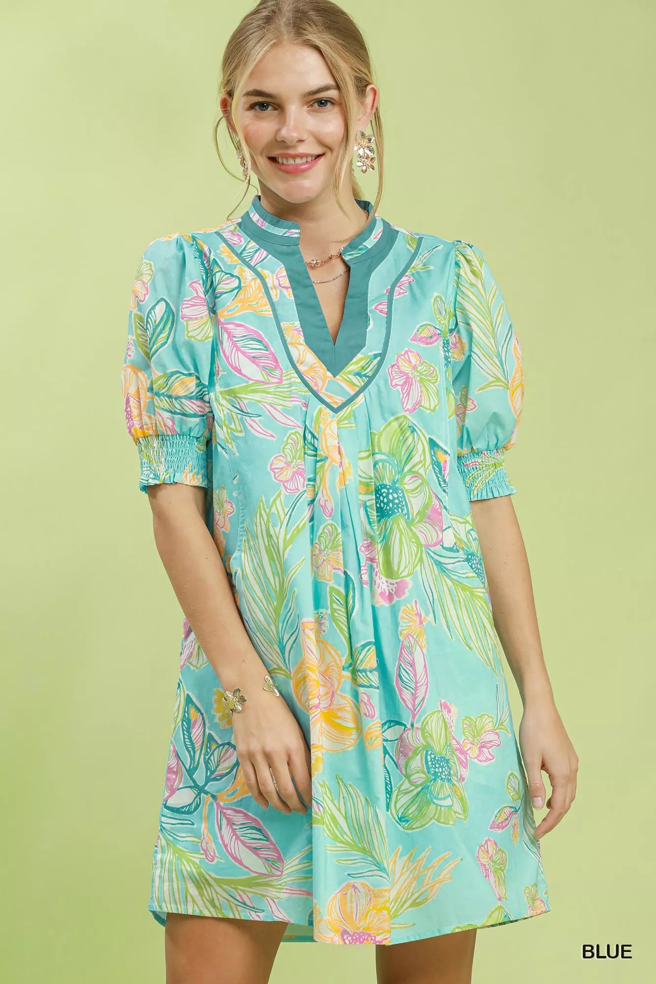 Blue Umgee botanical print dress with smocked cuffs, featuring a flowy silhouette and vibrant floral pattern.