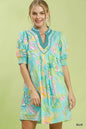Blue Umgee botanical print dress with smocked cuffs, featuring a flowy silhouette and vibrant floral pattern.