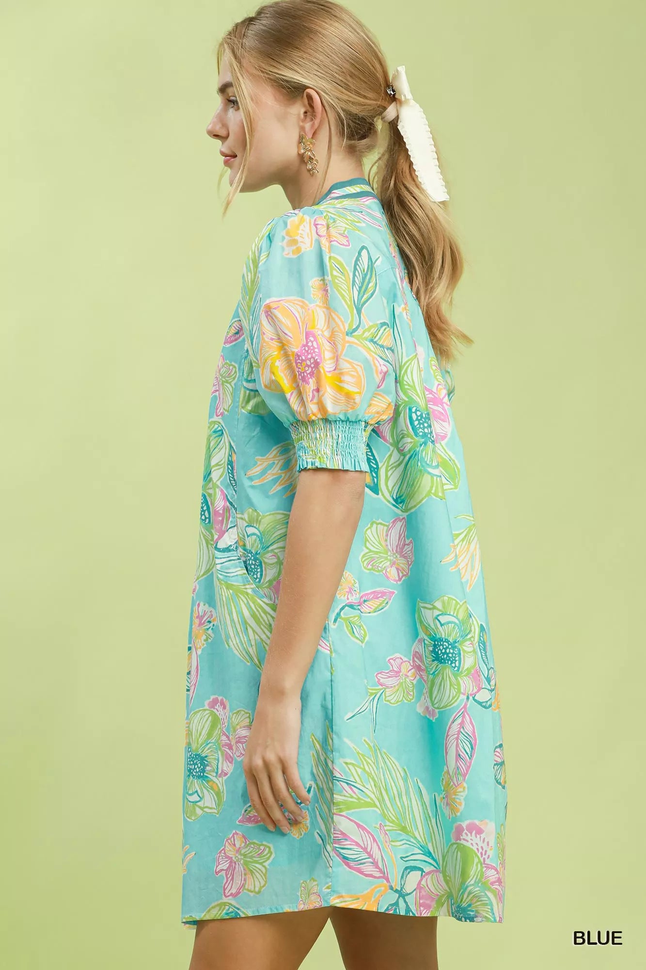 Blue Umgee botanical print dress with smocked cuffs, featuring a flowy silhouette and vibrant floral pattern.