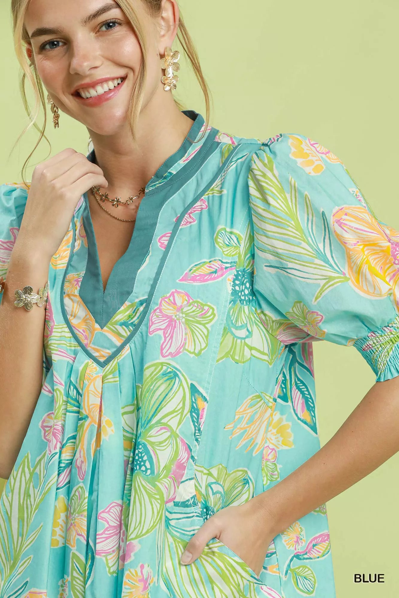 Blue Umgee botanical print dress with smocked cuffs, featuring a flowy silhouette and detailed floral pattern.