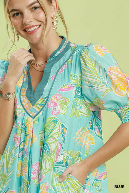 Blue Umgee botanical print dress with smocked cuffs, featuring a flowy silhouette and detailed floral pattern.