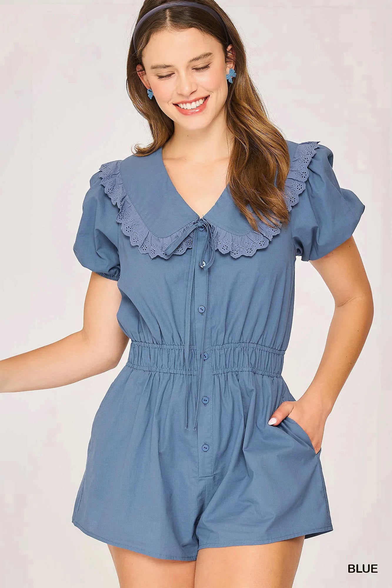 Blue Umgee collared short sleeve button-down romper by Trendsi, shown on a hanger with a casual, stylish fit.
