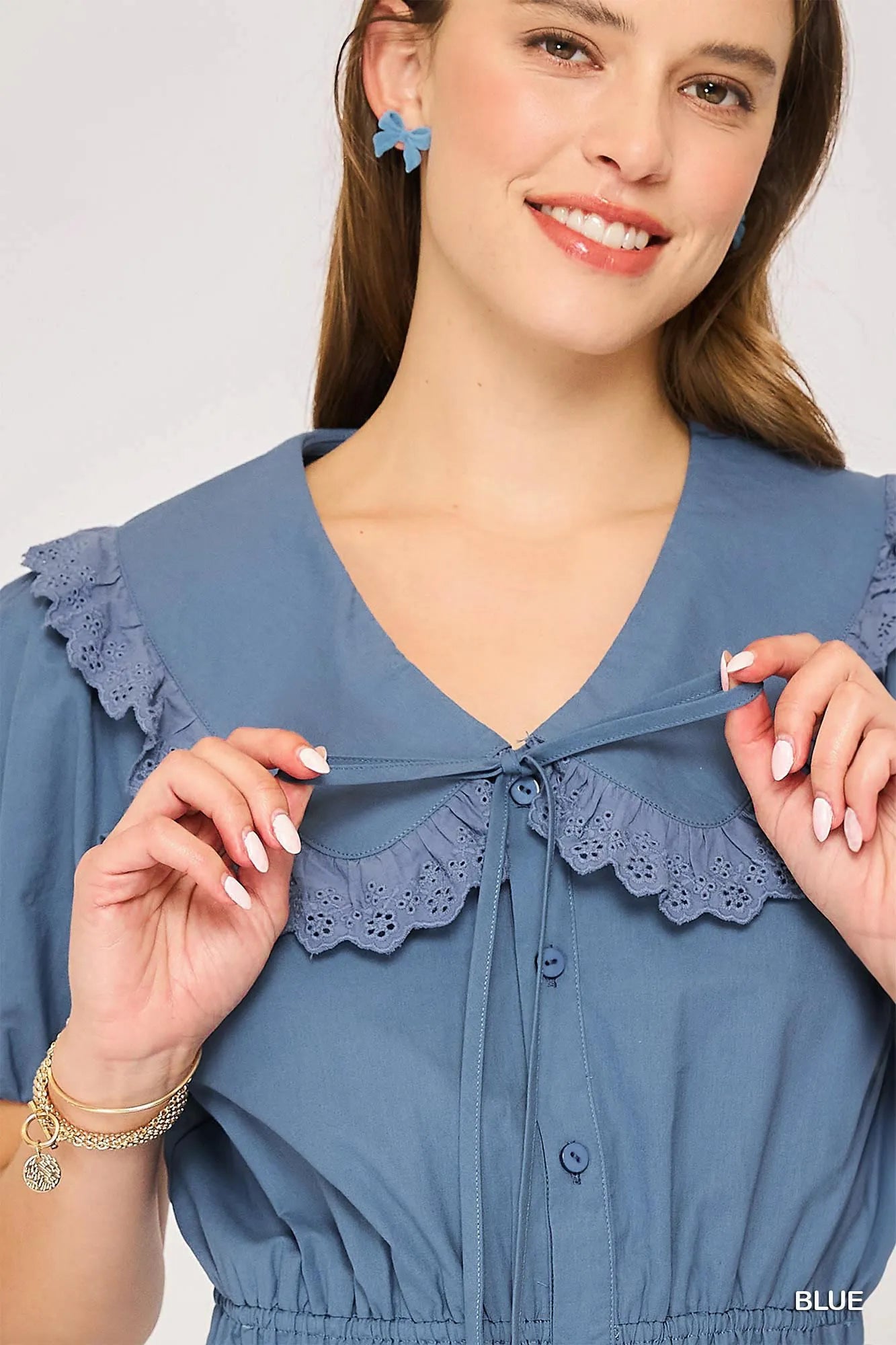 Blue Umgee short sleeve button-down romper with collar, featuring a relaxed fit and stylish design for casual wear.