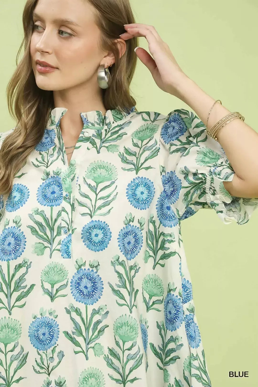 Blue Umgee floral puff sleeve babydoll dress with side pockets, featuring a relaxed fit and feminine design.