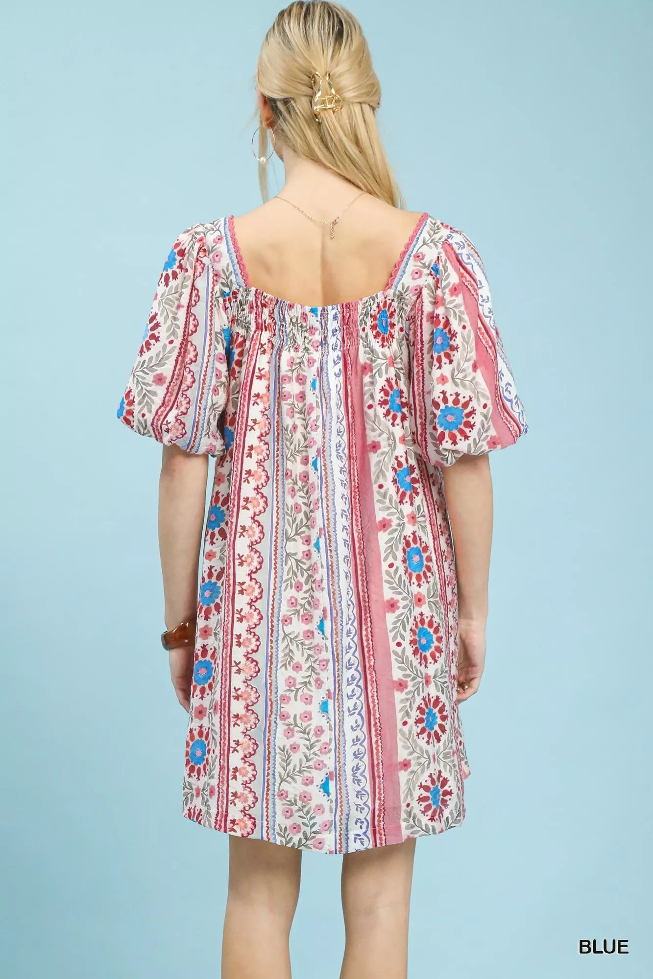Blue Umgee mixed print puff sleeve mini dress with a fitted bodice and short sleeves, perfect for casual or summer wear.