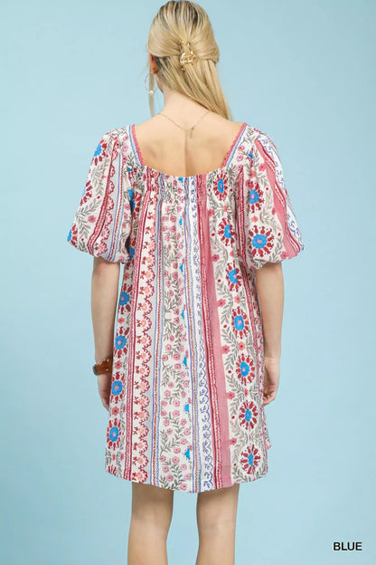 Blue Umgee mixed print puff sleeve mini dress with a fitted bodice and short sleeves, perfect for casual or summer wear.