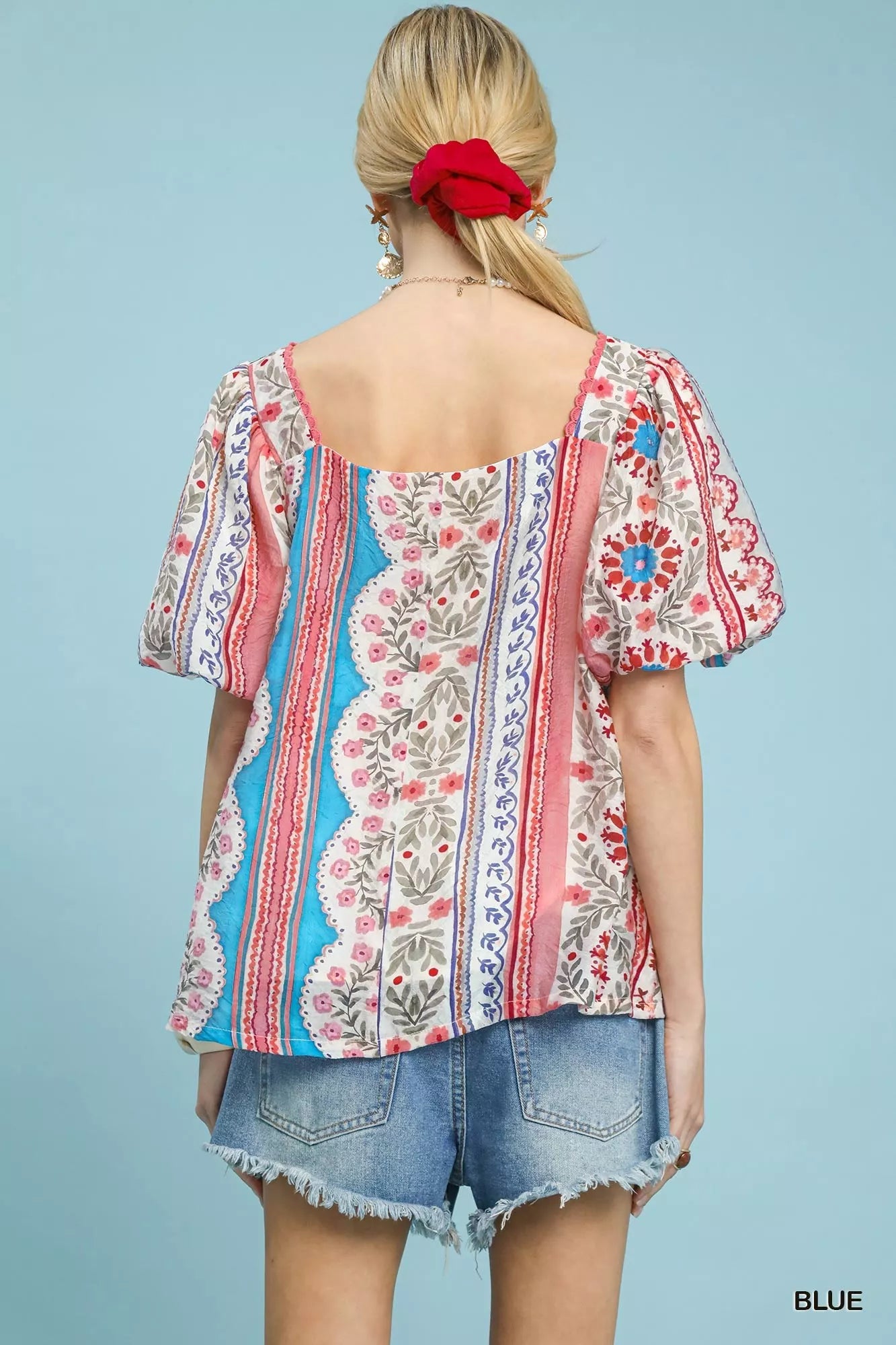Blue Umgee patchwork puff sleeve smocked blouse with ruffled details, showcasing trendy boho-inspired fashion.