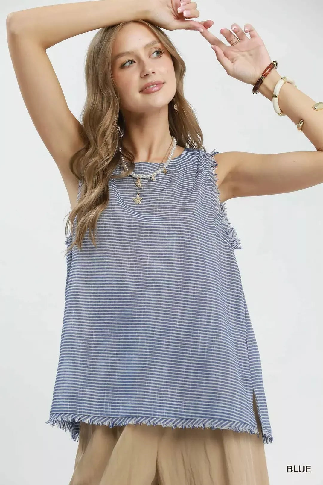 Blue Umgee sleeveless top with stripe pattern and fringe trim, featuring a casual, stylish design.
