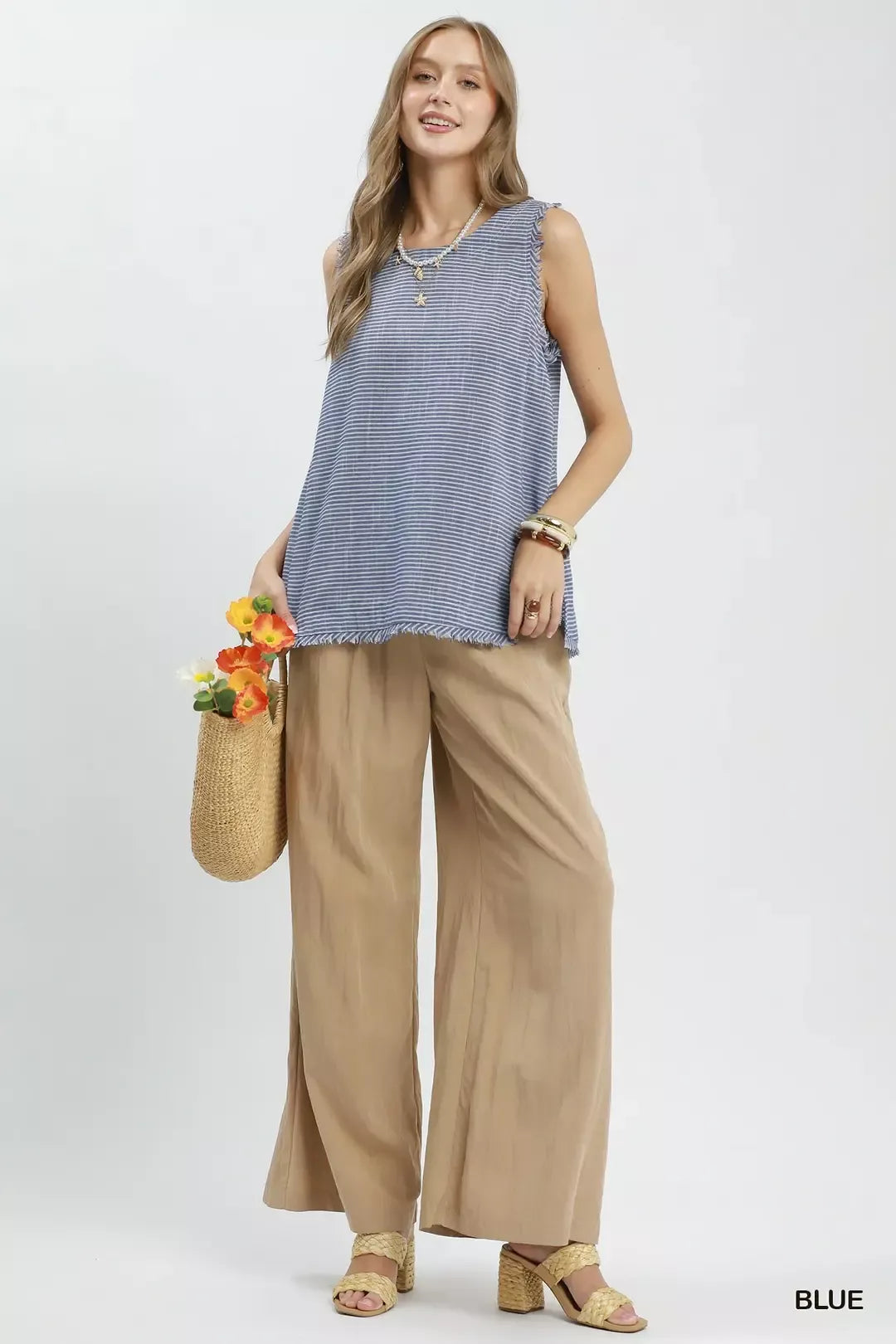 Blue Umgee sleeveless top with white stripe pattern and fringe trim, featuring a relaxed fit and casual style.