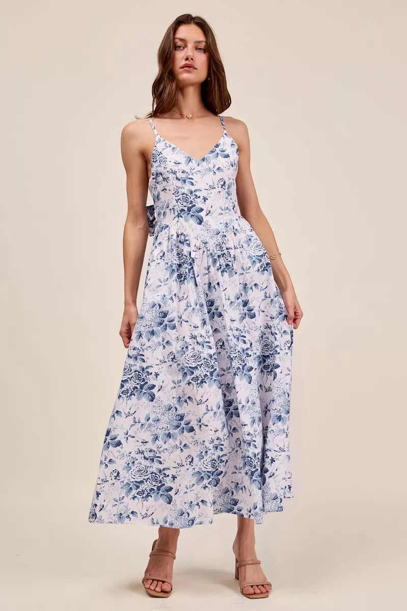 Blue floral woven V-neck dress with back ribbon tie by Trendsi, featuring a stylish, feminine design and lightweight fabric.