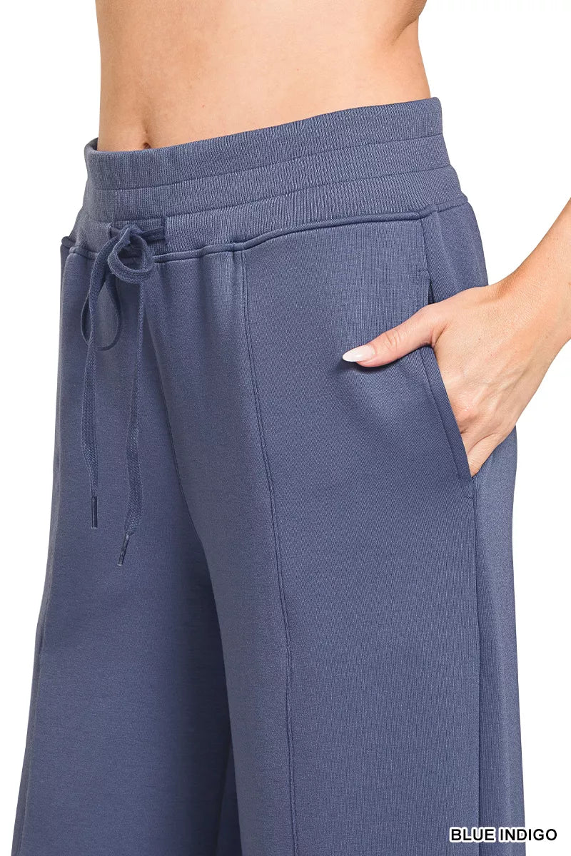 Blue Zenana scuba collared pullover and center seam pants set, stylish loungewear from Trendsi, shown on a model.