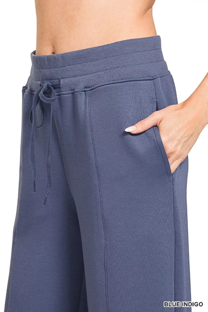 Blue Zenana scuba collared pullover and center seam pants set, stylish loungewear from Trendsi, shown on a model.