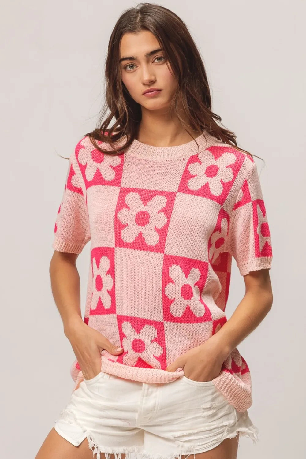 Blush pink and fuchsia BiBi Flower checker pattern short sleeve sweater by Trendsi, featuring a cozy knit design and vibrant floral pattern.