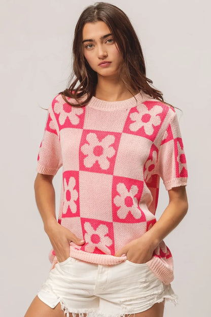 Blush pink and fuchsia BiBi Flower checker pattern short sleeve sweater by Trendsi, featuring a cozy knit design and vibrant floral pattern.