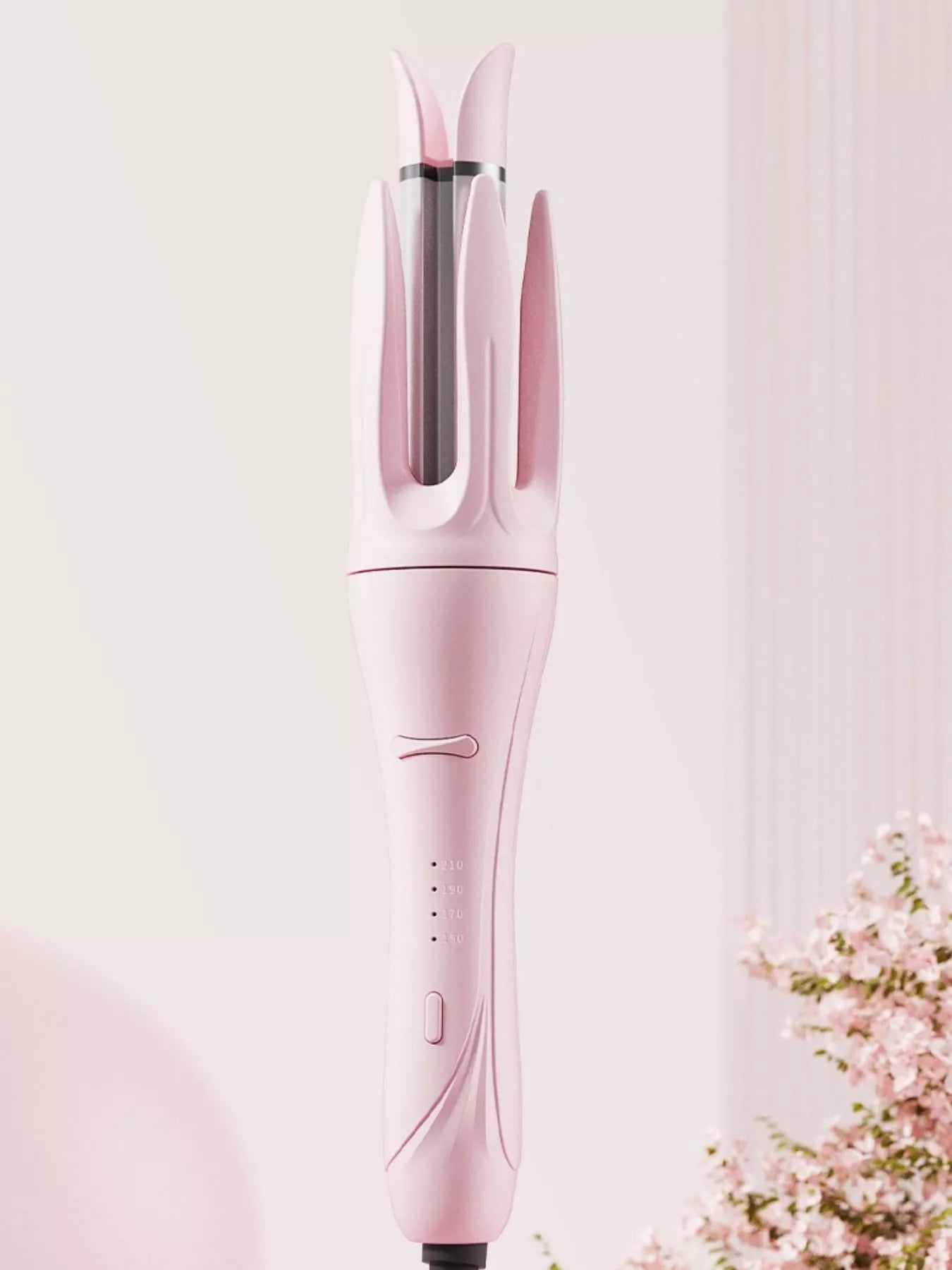 Blush pink automatic rotating ceramic curling iron by Trendsi with European plug for creating smooth, styled curls.