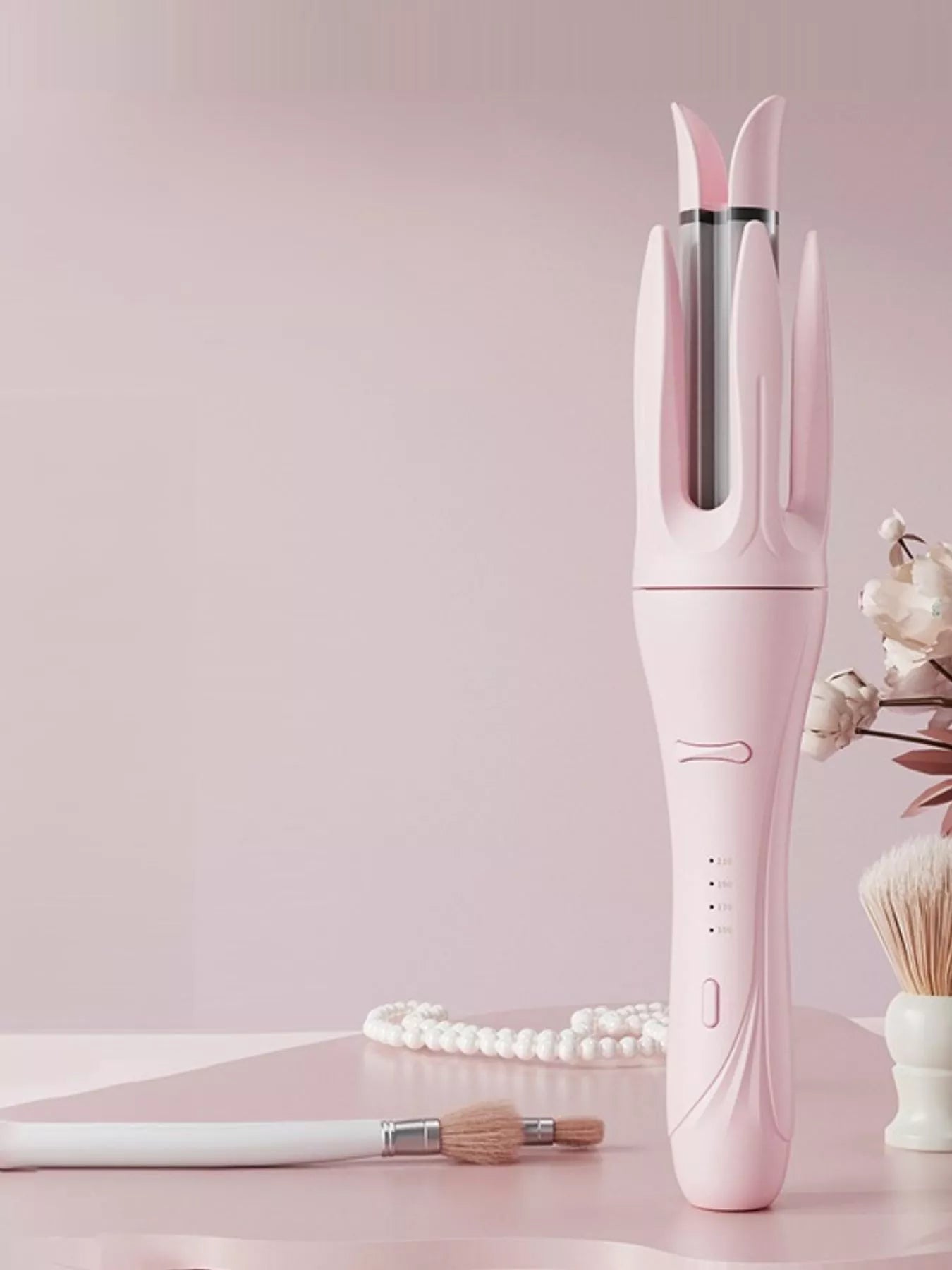 Blush pink automatic rotating ceramic curling iron by Trendsi with European plug, showcasing its sleek design and rotating barrel.