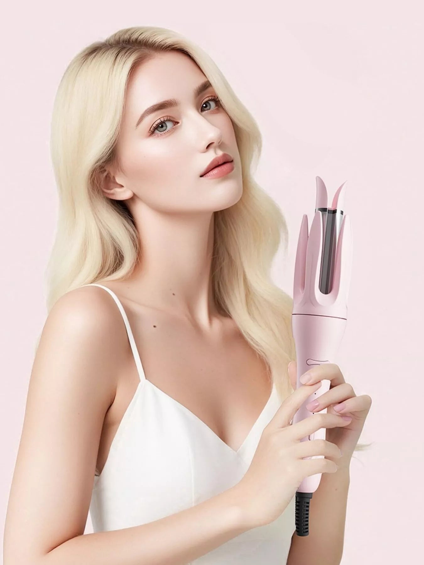 Blush pink automatic rotating ceramic curling iron with European plug by Trendsi, showcasing its sleek design and rotating barrel.