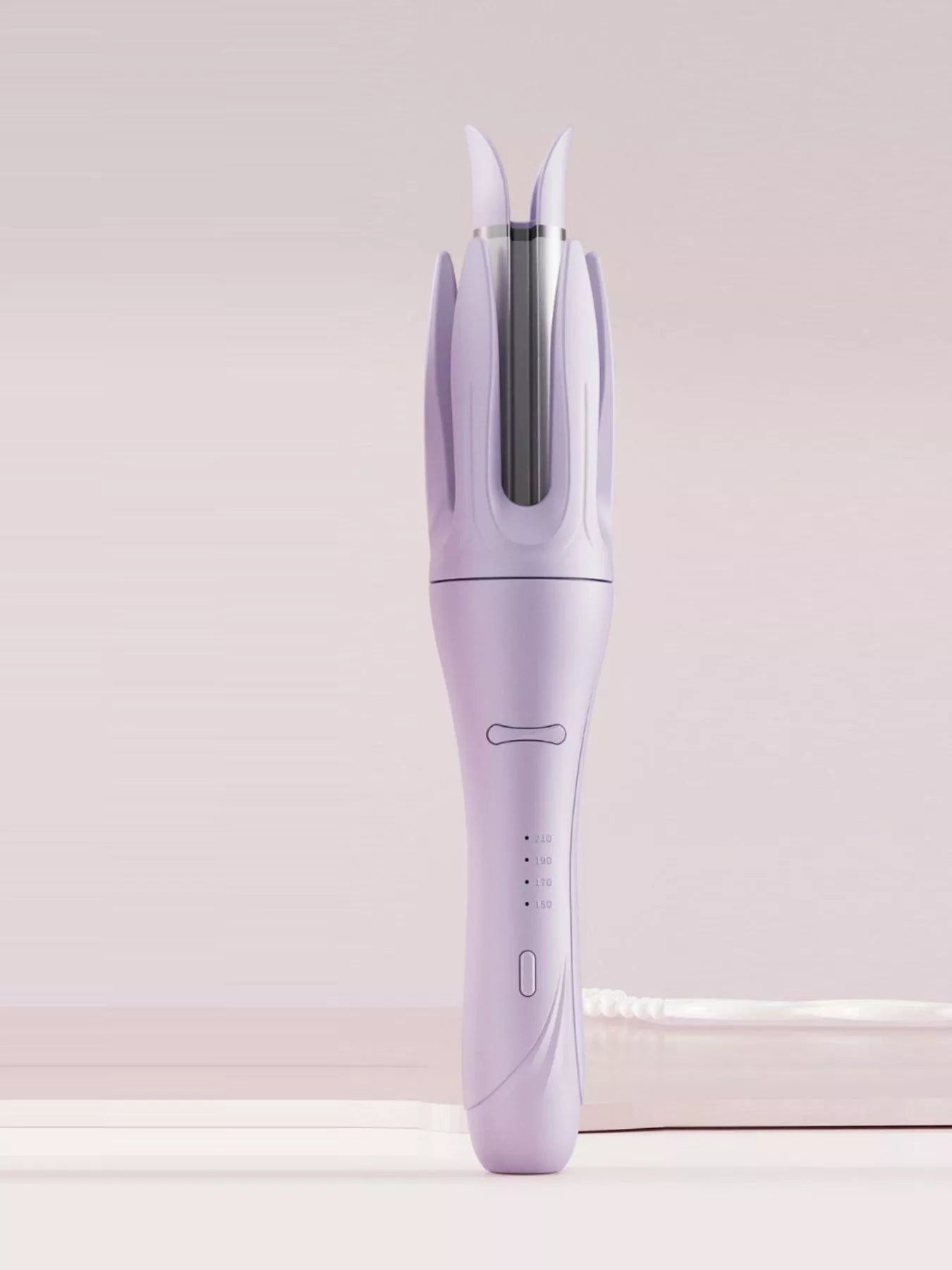 Blush pink automatic rotating ceramic curling iron by Trendsi with European plug for creating smooth, bouncy curls.