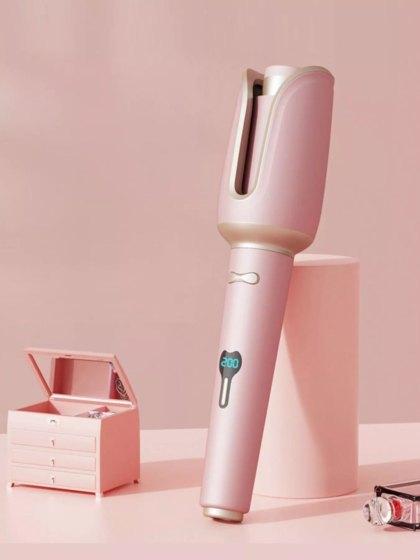 Blush pink automatic rotating ceramic hair curling iron with European plug by Trendsi, showing its sleek design and rotating barrel.