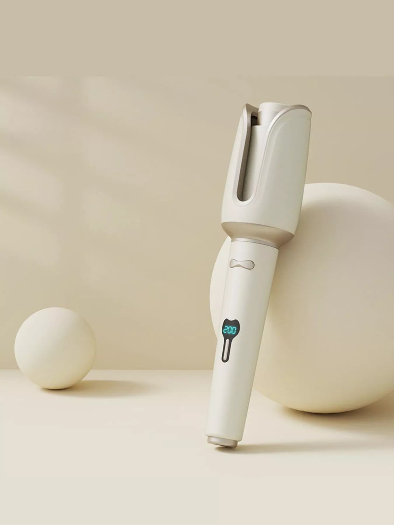 Blush pink automatic rotating ceramic hair curling iron with European plug, designed for creating smooth, even curls.