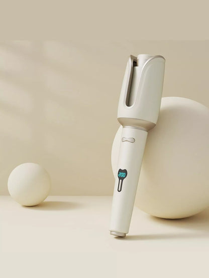 Blush pink automatic rotating ceramic hair curling iron with European plug, designed for creating smooth, even curls.