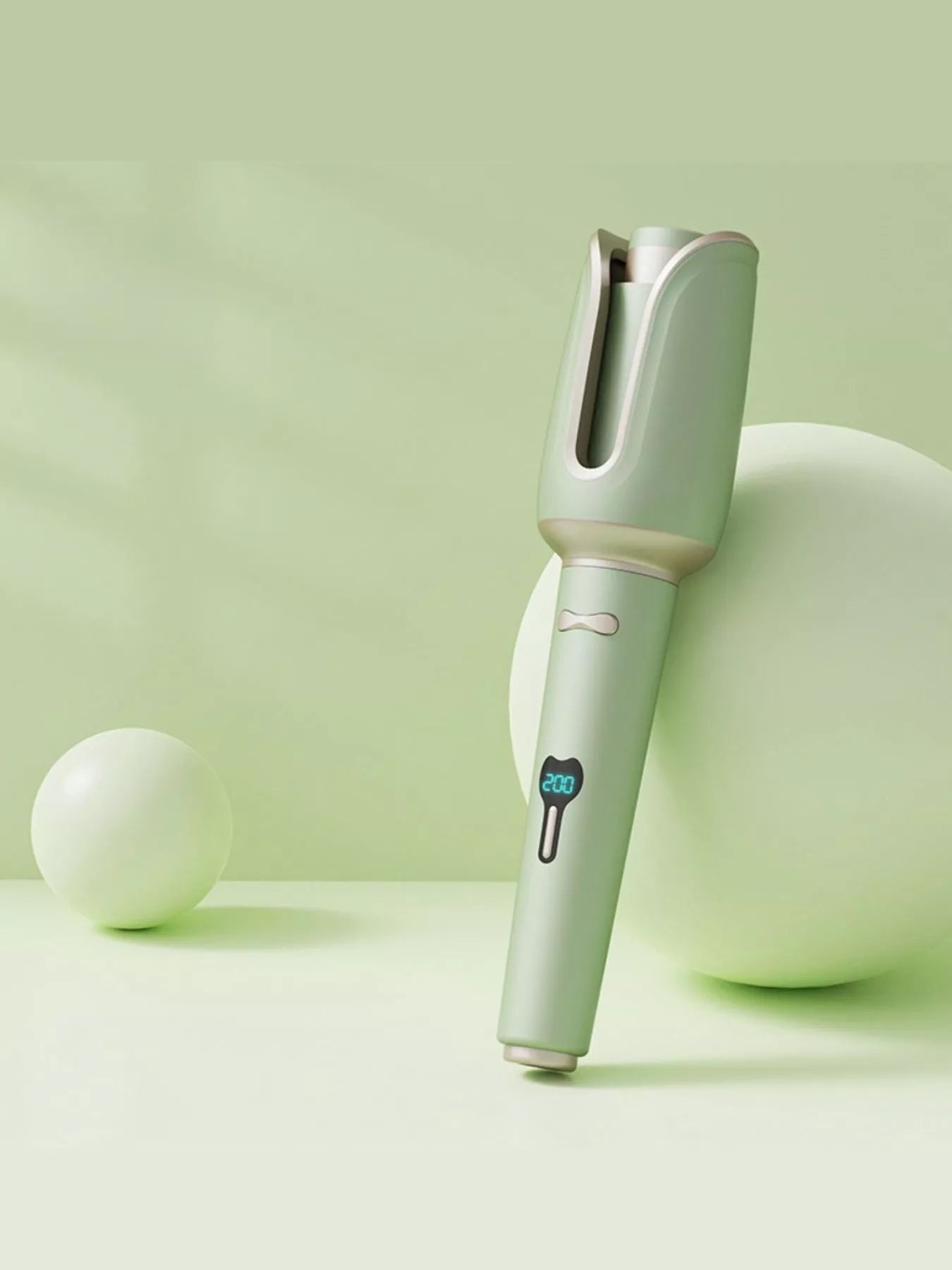 Blush pink automatic rotating ceramic hair curling iron with European plug from Trendsi, designed for creating smooth, styled curls.
