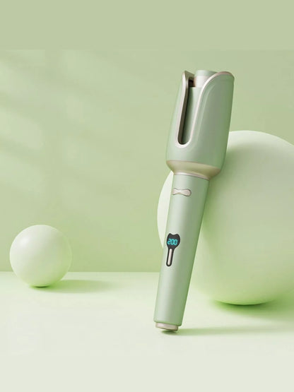 Blush pink automatic rotating ceramic hair curling iron with European plug from Trendsi, designed for creating smooth, styled curls.