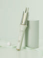 Blush pink automatic rotating ceramic hair curling iron by Trendsi with European plug for creating bouncy curls.