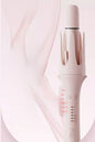 Blush pink automatic rotating curling iron by Trendsi with European plug, showcasing its sleek design and rotating barrel for curls.