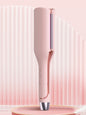 Blush pink Trendsi rotating ceramic hair curling iron with European plug for creating curls and waves.