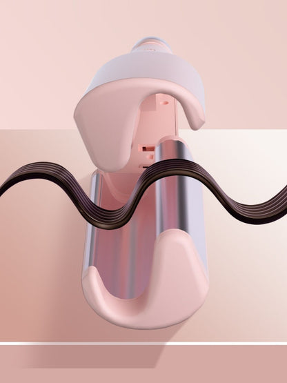 Blush pink Trendsi rotating ceramic hair curling iron with European plug, showing the curling barrel and handle.