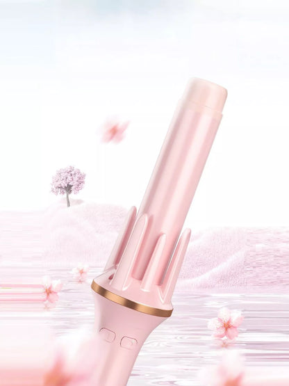 Blush pink automatic rotating hair curling iron by Trendsi with a sleek design for effortless curls