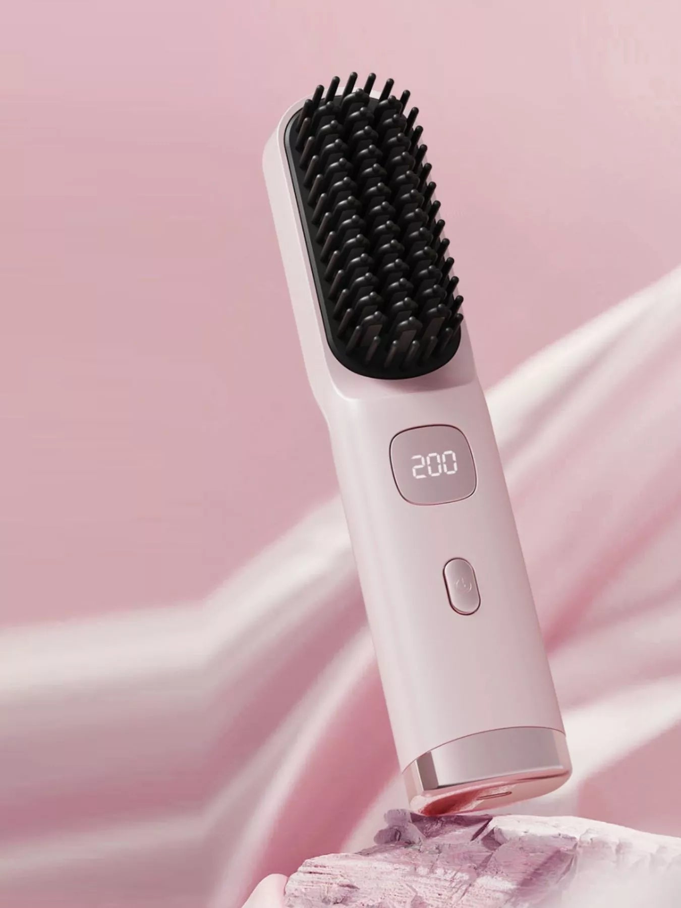 Blush pink Trendsi heated straightening comb with ergonomic handle for salon-quality hair styling.