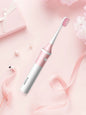 Blush pink Trendsi electric toothbrush with multiple cleaning modes on a white background.