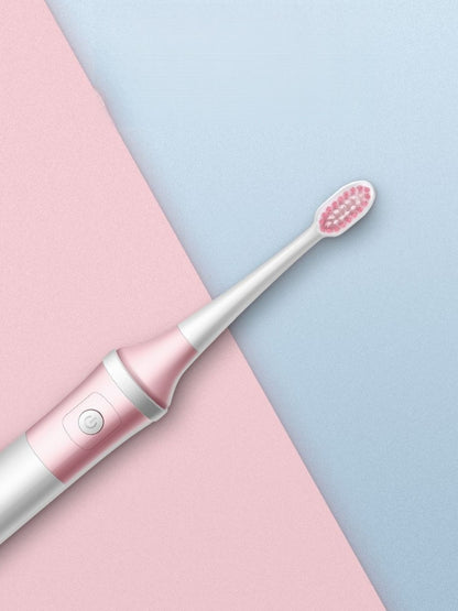 Blush pink electric toothbrush by Trendsi with multiple cleaning modes, featuring a sleek design and interchangeable brush heads.