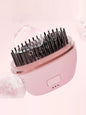 Blush pink portable heated hair straightening comb by Trendsi, compact design with adjustable heat settings for easy styling.