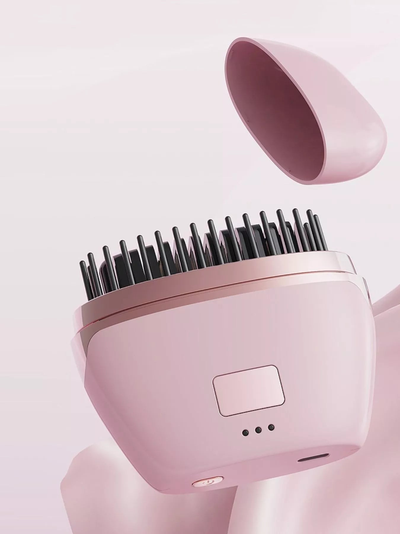 Blush pink portable heated hair straightening comb by Trendsi, compact design for easy styling and hair straightening.
