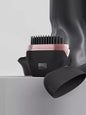 Blush pink portable heated hair straightening comb by Trendsi, compact design for easy styling at home or on the go.